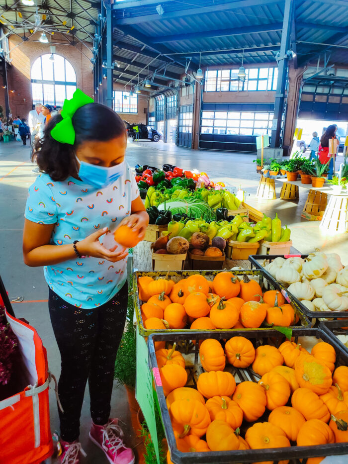 Zhen picks out mini pumpkins at Eastern Market.