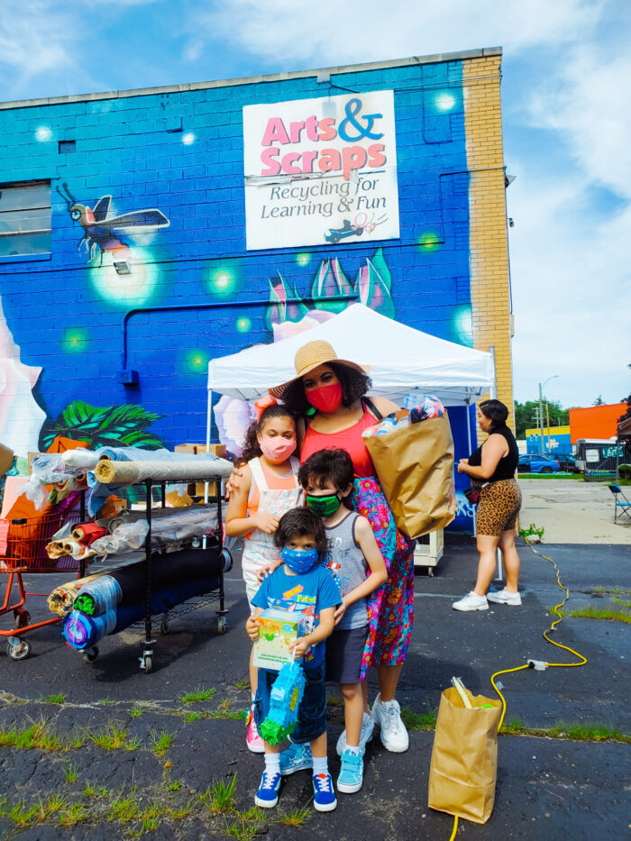 A family poses for a photo at the Arts and Scraps summer festival in Detroit in 2021.